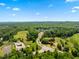 Aerial view of a community featuring a winding road and abundant green space with mature trees at 46 Waterfall Pointe, Chapel Hill, NC 27517
