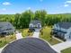 Aerial view showcasing the neighborhood, tree coverage and exterior of home with a two car garage and manicured lawn at 46 Waterfall Pointe, Chapel Hill, NC 27517