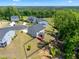 Aerial view of homes featuring a fenced in backyard and a wooden deck surrounded by lush greenery and mature trees at 46 Waterfall Pointe, Chapel Hill, NC 27517