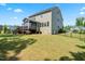 Expansive backyard with a lush lawn, screened porch, and a view of the back of the house at 46 Waterfall Pointe, Chapel Hill, NC 27517