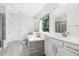 Bright bathroom featuring a soaking tub, double vanity, and a separate shower area with natural light streaming through the window at 46 Waterfall Pointe, Chapel Hill, NC 27517