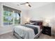 Cozy bedroom featuring a large window with neighborhood views and ceiling fan at 46 Waterfall Pointe, Chapel Hill, NC 27517