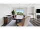 Charming dining room features a decorative fixture, stylish rug, and a view into the living room at 46 Waterfall Pointe, Chapel Hill, NC 27517