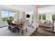 Light filled dining room with decorative lighting fixture, stylish rug, and a table that seats six at 46 Waterfall Pointe, Chapel Hill, NC 27517
