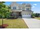 Charming two-story home featuring stone accents, a covered porch, a well-manicured lawn, and an attached two-car garage at 46 Waterfall Pointe, Chapel Hill, NC 27517