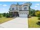 Charming two-story home featuring a two-car garage, covered porch, and manicured lawn at 46 Waterfall Pointe, Chapel Hill, NC 27517