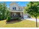 Beautiful two-story home with a welcoming front porch, stone accents, a two-car garage, and a landscaped front yard at 46 Waterfall Pointe, Chapel Hill, NC 27517