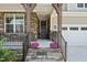 Inviting front porch with stone accents, a covered entry, decorative plants, and steps leading up to the front door at 46 Waterfall Pointe, Chapel Hill, NC 27517