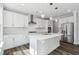 Contemporary kitchen featuring white cabinets, stainless steel appliances, and a stylish subway tile backsplash at 46 Waterfall Pointe, Chapel Hill, NC 27517