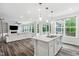 Bright kitchen featuring a large center island, pendant lighting, and open views into the adjacent living room at 46 Waterfall Pointe, Chapel Hill, NC 27517