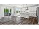 Bright eat-in kitchen with white cabinets, subway tile backsplash, stainless appliances, and access to screened deck at 46 Waterfall Pointe, Chapel Hill, NC 27517