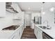 Well-appointed kitchen with stainless steel appliances, white cabinets and modern gas cooktop for culinary enthusiasts at 46 Waterfall Pointe, Chapel Hill, NC 27517
