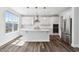 Beautiful kitchen featuring a stainless steel refrigerator, a kitchen island, and subway tile backsplash with lots of light at 46 Waterfall Pointe, Chapel Hill, NC 27517