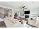 Bright living room boasts modern fireplace, built-in shelves, ceiling fan, and stylish hardwood flooring at 46 Waterfall Pointe, Chapel Hill, NC 27517