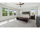 Bright main bedroom with large windows, ceiling fan, and tray ceiling at 46 Waterfall Pointe, Chapel Hill, NC 27517