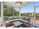 Relaxing screened porch with comfortable seating, a ceiling fan, and views of the backyard and surrounding trees at 46 Waterfall Pointe, Chapel Hill, NC 27517