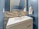 Modern bathroom with mosaic tile backsplash, sleek vanity, and framed mirror at 468 Hay River St, Garner, NC 27529
