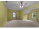 Light-filled bedroom with neutral carpet, ceiling fan, and natural lighting at 468 Hay River St, Garner, NC 27529