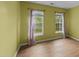 Well-lit bedroom featuring hardwood floors and two windows adorned with light purple curtains at 468 Hay River St, Garner, NC 27529