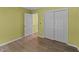 Bright bedroom featuring hardwood floors, light yellow walls, and a spacious closet at 468 Hay River St, Garner, NC 27529