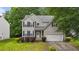 Charming two-story home featuring gray siding, a manicured lawn, and an attached two-car garage at 468 Hay River St, Garner, NC 27529