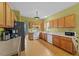 Spacious kitchen featuring wood cabinetry, modern appliances, and ample counter space at 468 Hay River St, Garner, NC 27529