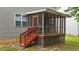 Enclosed sunroom with wooden stairs, screens, and access to the backyard at 468 Hay River St, Garner, NC 27529