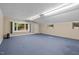 Spacious basement with blue carpeting, natural light, and neutral-toned walls at 4701 Brock Dr, Hurdle Mills, NC 27541