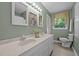 Bathroom boasts a dual sink vanity, picture frame mirrors, and natural light at 4701 Brock Dr, Hurdle Mills, NC 27541