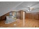 Comfortable bedroom with wood-paneled walls, wood floors, and a cozy bed at 4701 Brock Dr, Hurdle Mills, NC 27541