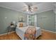 Cozy bedroom featuring a ceiling fan, hardwood floors, and bright natural light at 4701 Brock Dr, Hurdle Mills, NC 27541