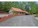 Charming one-story home with a metal roof, brick foundation, and a spacious driveway at 4701 Brock Dr, Hurdle Mills, NC 27541
