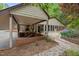 Charming one-story home with a metal roof, covered patio, and beautiful landscaping at 4701 Brock Dr, Hurdle Mills, NC 27541
