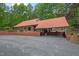 Charming one-story home with metal roof, brick foundation, covered patio, and large driveway at 4701 Brock Dr, Hurdle Mills, NC 27541