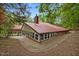 Beautiful home with covered patio, brick foundation, and a metal roof surrounded by trees at 4701 Brock Dr, Hurdle Mills, NC 27541