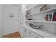 Hallway features hardwood floors, white textured walls and built-in shelving at 4701 Brock Dr, Hurdle Mills, NC 27541