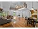 Open-concept living area with hardwood floors, a lofted ceiling, and a dining table set at 4701 Brock Dr, Hurdle Mills, NC 27541