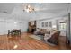 Spacious living room with hardwood floors, a brick fireplace, and ample natural light at 4701 Brock Dr, Hurdle Mills, NC 27541
