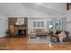Cozy living room with a brick fireplace, hardwood floors, and comfortable seating at 4701 Brock Dr, Hurdle Mills, NC 27541