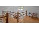 Wood railings look out from loft with distant view of the living room below at 4701 Brock Dr, Hurdle Mills, NC 27541