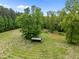 Aerial shot of large lot with storage shed surrounded by trees at 4701 Brock Dr, Hurdle Mills, NC 27541