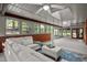 Cozy sunroom with brick walls, windows, skylights and comfortable seating at 4701 Brock Dr, Hurdle Mills, NC 27541