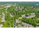 An elevated aerial view capturing a well-maintained residential area with tree-lined streets and varied housing at 4703 Kings Garden Rd, Raleigh, NC 27612