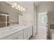 Bathroom with double sinks, vanity, and separate shower and tub at 4703 Kings Garden Rd, Raleigh, NC 27612