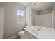 Bright bathroom features a single sink vanity, window, toilet and shower/tub combination at 4703 Kings Garden Rd, Raleigh, NC 27612