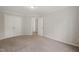 Large bedroom with neutral carpet and two closets on the back wall at 4703 Kings Garden Rd, Raleigh, NC 27612