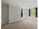 Spacious bedroom with neutral carpet, crown molding, and windows providing natural light at 4703 Kings Garden Rd, Raleigh, NC 27612