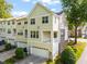 Exterior view of townhome with light siding, garages, and second-story balconies at 4703 Kings Garden Rd, Raleigh, NC 27612