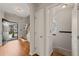 Foyer with hardwood floors, staircase, and coat rack with open door to the outside at 4703 Kings Garden Rd, Raleigh, NC 27612