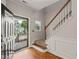 Welcoming foyer featuring hardwood floors, staircase with white wainscoting, and an inviting open entry at 4703 Kings Garden Rd, Raleigh, NC 27612